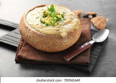 Broccoli Cheddar Soup In Bread Bowl On Wooden Board