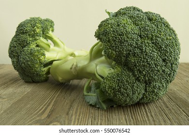 Broccoli Crowns Resting On A Wood Table