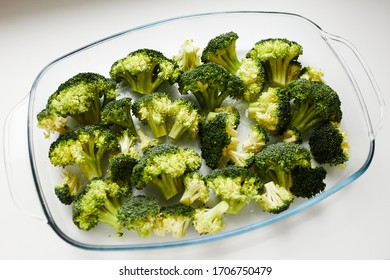 Broccoli In The Glass Baking Dish Prepared For Baking. On The White Table. Diet Recipe