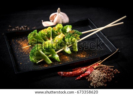 broccoli  mala grilled on table with blackground (selective focusing)