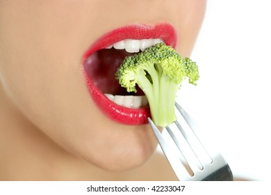 Broccoli On Steel Fork In Woman Mouth With Red Lips