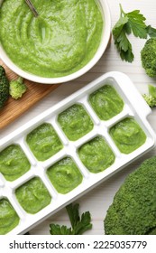 Broccoli Puree In Ice Cube Tray And Ingredients On White Wooden Table, Flat Lay. Ready For Freezing