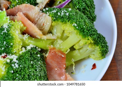 Broccoli salad with bacon, parmesan and garlic, ketogenic low-carb diet food top view macro