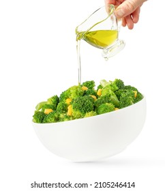 Broccoli Salad Bowl And Hand Pouring Olive Oil, Isolated On White Background.