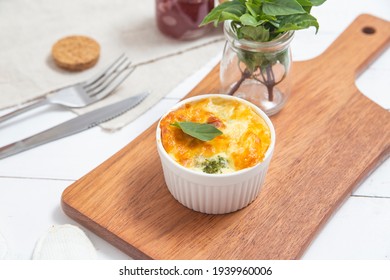 Broccoli Souffle With Bacon On A Kitchen Board And Cutlery