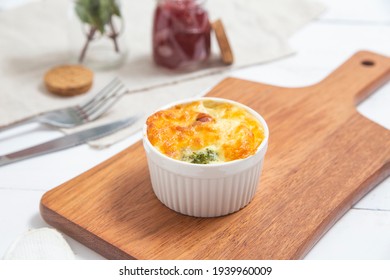 Broccoli Souffle With Bacon On A Kitchen Board And Cutlery