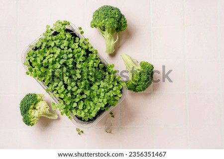 Broccoli sprouts and cabbage on pink background. Rich a phytochemicals sulforaphane and antioxidants with anti cancer and anti-inflammation action