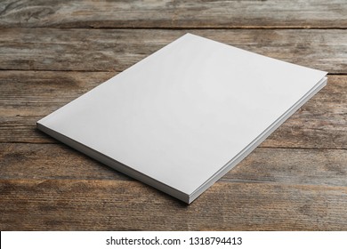 Brochure with blank cover on wooden background. Mock up for design - Shutterstock ID 1318794413