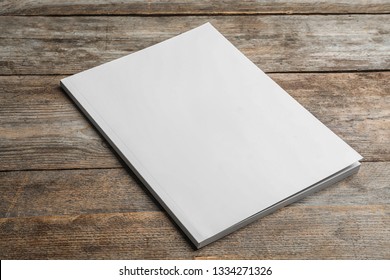 Brochure with blank cover on wooden background. Mock up for design - Shutterstock ID 1334271326