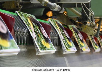 Brochure and magazine stitching process. Close-up of the  offset conveying process of a full-automatic stitching unit.