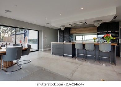 Brockley Green, Suffolk, England - January 28 2020: Modern Contemporary Kitchen Family Room With Breakfast Bar And Stools