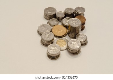 Brockville, Ontario, Canada - October 29, 2016. Canadian coins stacked in columns viewed from an above angle on a white background.