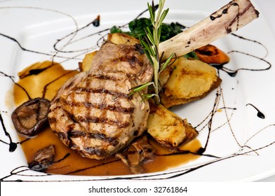 Broiled Center Cut Veal Chop With Sauteed Onions And Mushrooms.