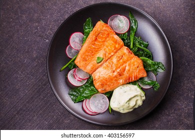 Broiled Salmon With Radish And Spinach, Served On Black Plate. View From Above, Top Studio Shot