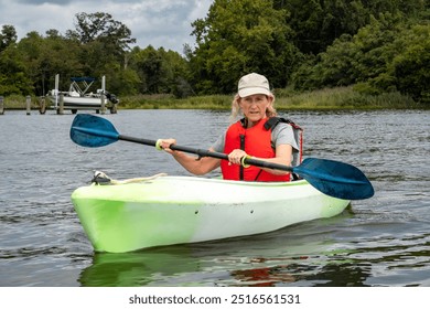 Broiomes Island, Maryland USA A woman kayaks in the Patuxent River in the summer. - Powered by Shutterstock