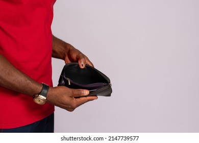 Broke African Man Holding An Empty Wallet