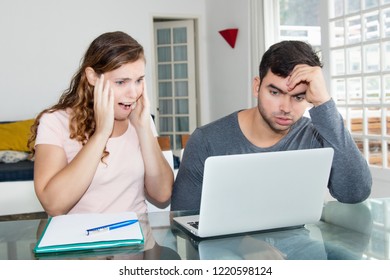 Broke couple with online bank account needs money at home - Shutterstock ID 1220598124
