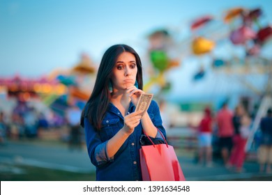 Broke Woman Holding one Dollar at Summer Funfair. Millennial thinking what to buy at cheap price on sale
 - Shutterstock ID 1391634548
