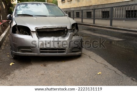 Broken, abandoned car in the city