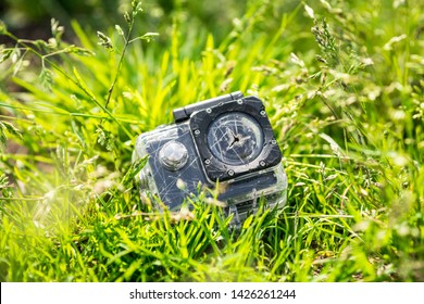 broken action camera in a protective case in the grass