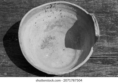 Broken Antique Clay Pot On A Wooden Table In The History Museum. Shard Of Old Clay Jar, Pitcher Or Ceramic Pot. Black And White Picture