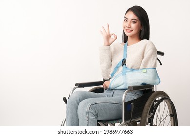 Broken Arm Beautiful Young Asian With Happy Smiling Woman In A Wheelchair On White Background, Healthcare Concept, Accident, Insurance, Life Insurance, Wellness, Hospital.