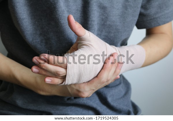 Broken arm concept. Cast\
broken arm for immobilize after arm and hand injury. Hand wrapped\
in bandage