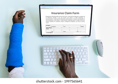 Broken Arm Injured Worker Compensation Coverage. Using Office Laptop - Shutterstock ID 1997565641