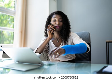 Broken Arm Injured Worker Compensation Coverage. Using Office Laptop - Shutterstock ID 2005760852