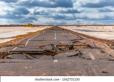broken asphalt road with cloudy sky in the middle of the  Lut desert,hottest desert in the world, also known like Kalut Desert