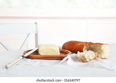 Broken Baguette And Butter On Light Background