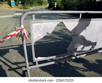 Broken Barricade With Striped Ribbon On Road