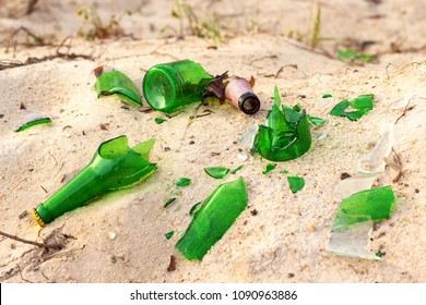 Broken Beer Glass Bottles On A Sand