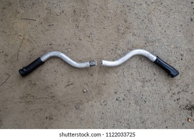 A broken bicycle handlebar lies on the ground - Powered by Shutterstock