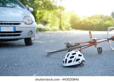 Broken Bicycle On The Asphalt After Car Crash Incident