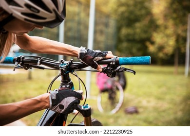 Broken Bike While Riding In The Park. Senior Female Have Trouble With Bicycle Outdoor. Sporty Mature Woman Cyclist Fixing Her Bike