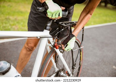 Broken bike while riding in the Park. Senior female have trouble with bicycle outdoor. Sporty Mature Woman cyclist fixing her bike - Powered by Shutterstock