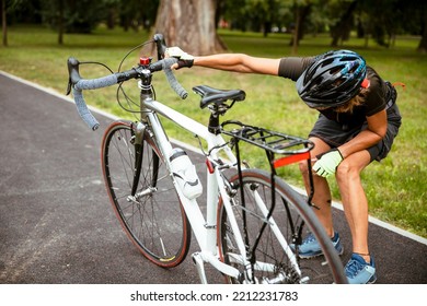 Broken Bike While Riding In The Park. Senior Female Have Trouble With Bicycle Outdoor. Sporty Mature Woman Cyclist Fixing Her Bike