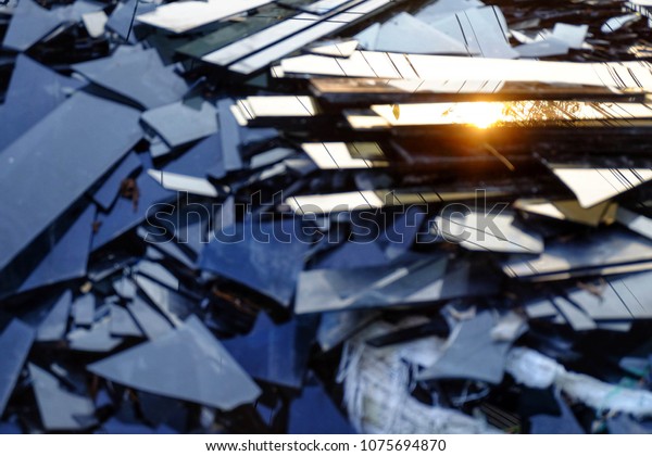 Broken black glass,Heap of mirror\
fragments,broken black mirror to\
recycle.