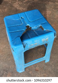 Broken blue plastic chair