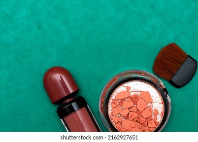 Broken Blush, Lipstick And Brush  Isolated On Green Background