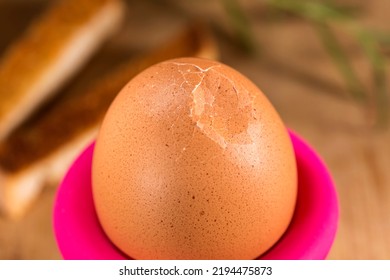 Broken Boiled Egg For Breakfast On A Old Wooden Table In Eggcup