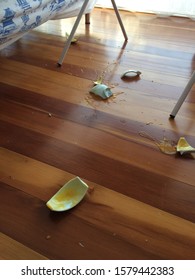 A Broken Bowl On A Wooden Floor In The Living Room