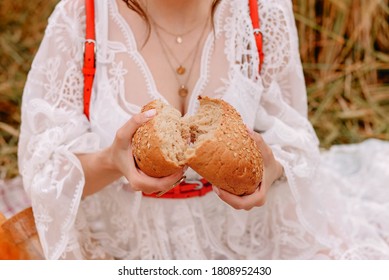 broken bread in women's hands