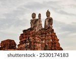 Broken Buddha statues at Wat Chaiwatthanaram: Weathered remnants of ancient figures, symbolizing the passage of time and Ayutthaya