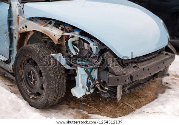 Broken car after an accident. Auto crash, wreck\
with damage injury. Street, traffic collision. Broken metal.\
Automobile insurance, safety, repair and transportation. Road\
dangerous drive.