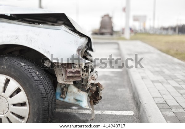 broken car after\
the accident in \
foreground