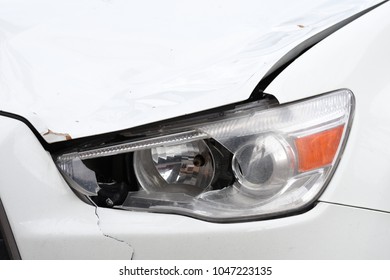 Broken Car Headlamp  On A White Car