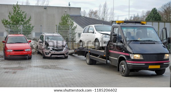 Broken car on tow\
truck after traffic\
accident