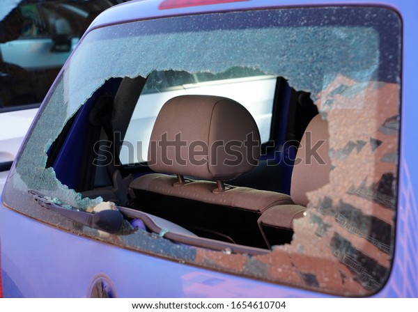 Broken\
car rear window. Busted back window of car. Rear windscreen of car\
smashed up, car back window broken and\
crashed.